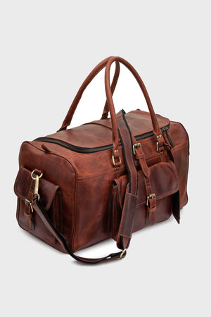 Cognac leather duffel bag showing front and side flap pockets