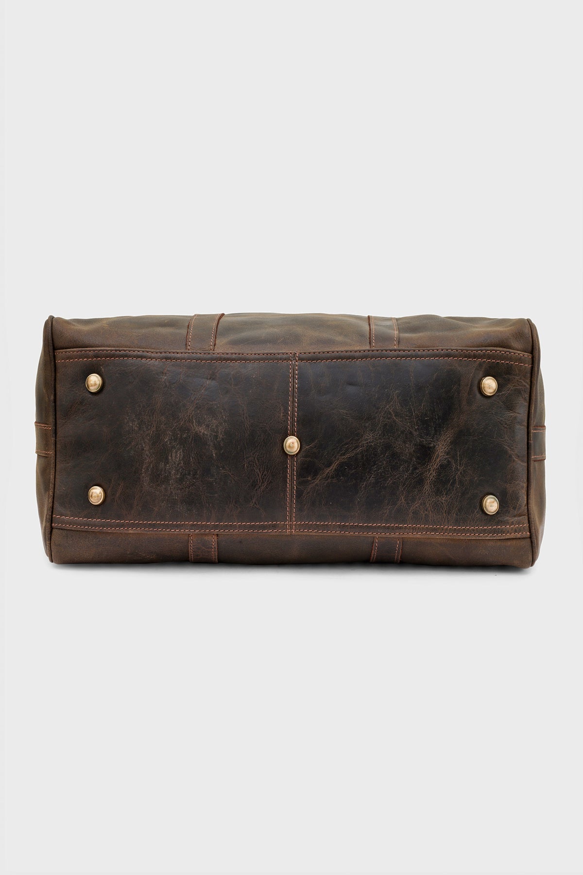 Base of the duffel bag showing protective brass studs