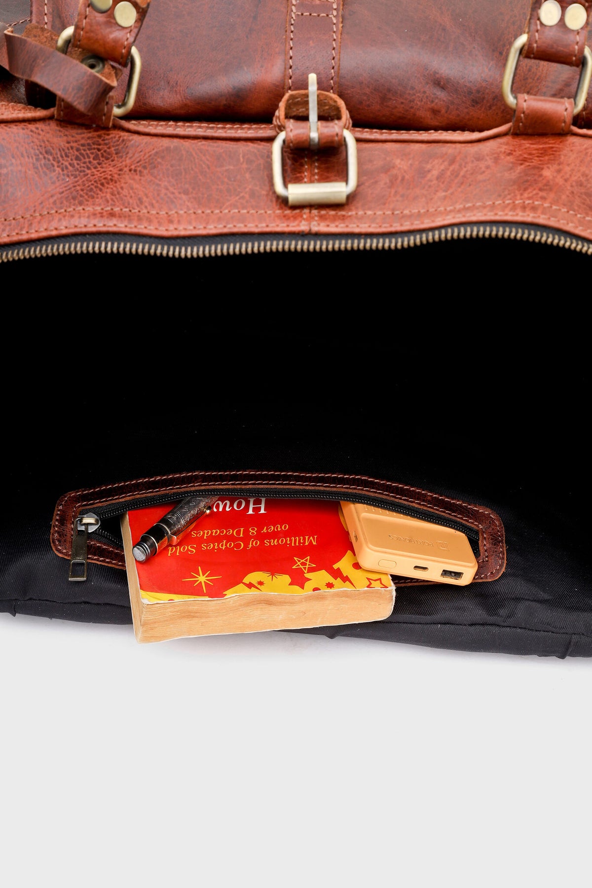 Interior of the Cognac duffel bag with zippered wall pocket in use
