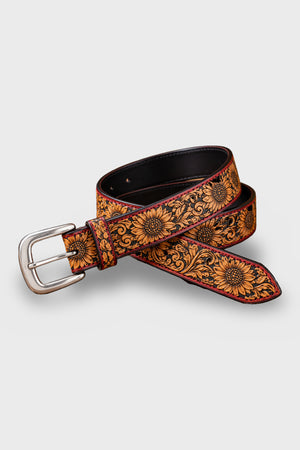Sunflower hand-tooled tan leather belt coiled, showing buckle and tooled strap