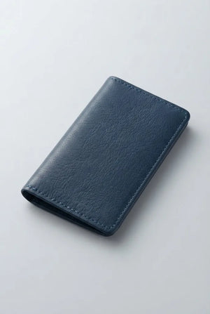 Artizanni mini leather travel journal in navy blue, angled view