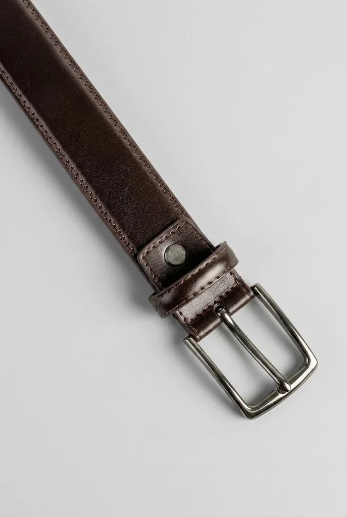 Close-up of brown leather dress belt buckle and prong hardware