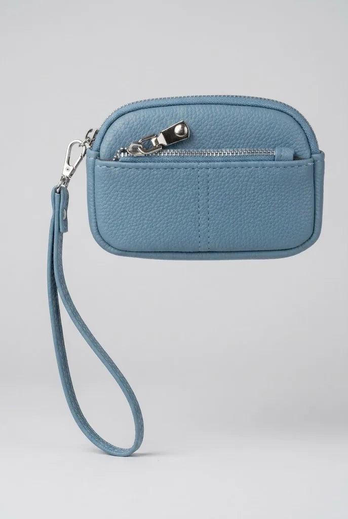 Ladies coin pouch wristlet in denim blue showing rear slip pocket