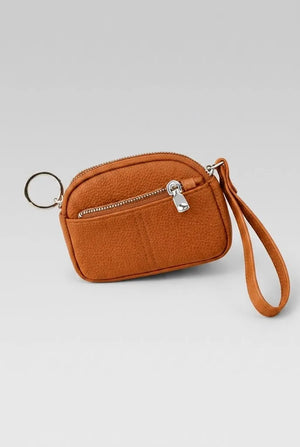 Women's coin pouch wristlet in rust orange with wrist strap