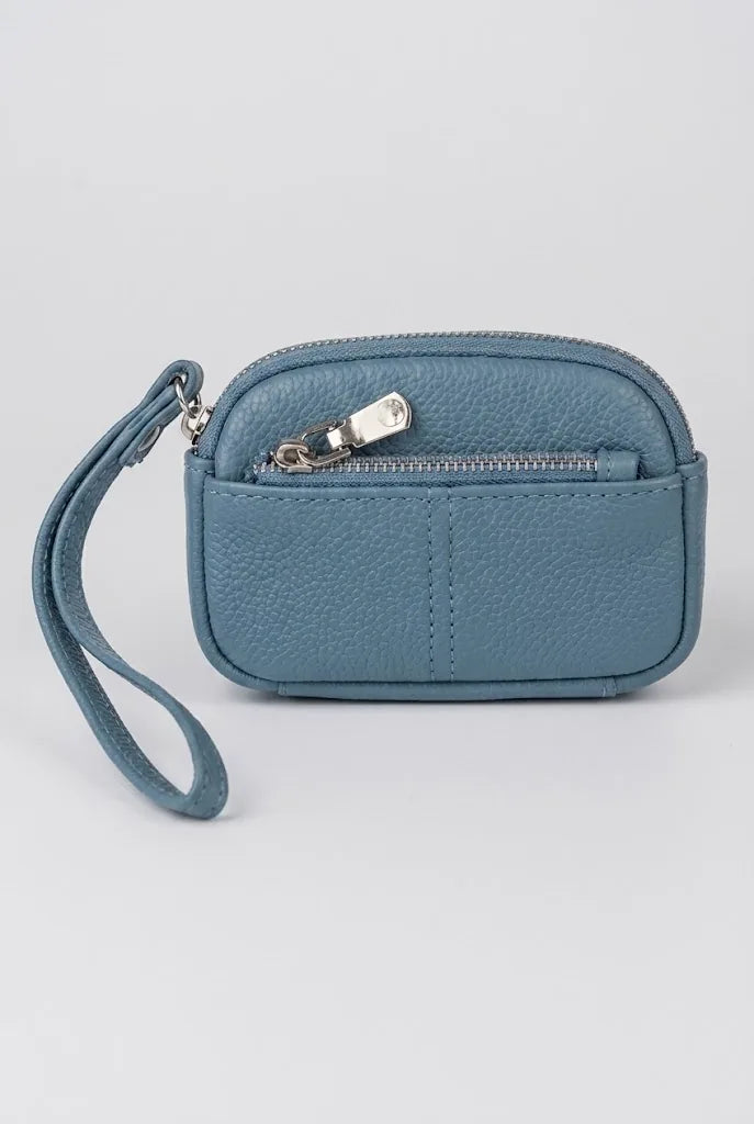 Blue coin pouch wristlet angled view showing zip pull and strap
