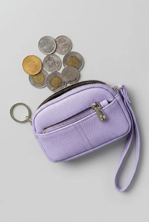Lilac coin pouch wristlet shown with assorted coins