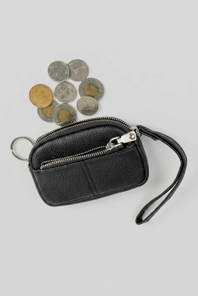 Black coin pouch wristlet with coins, showing everyday carry capacity