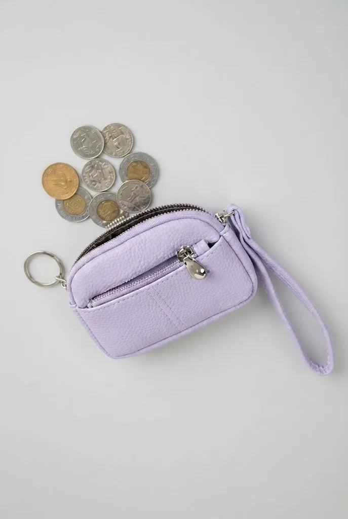 Purple coin pouch wristlet displayed with coins beside it